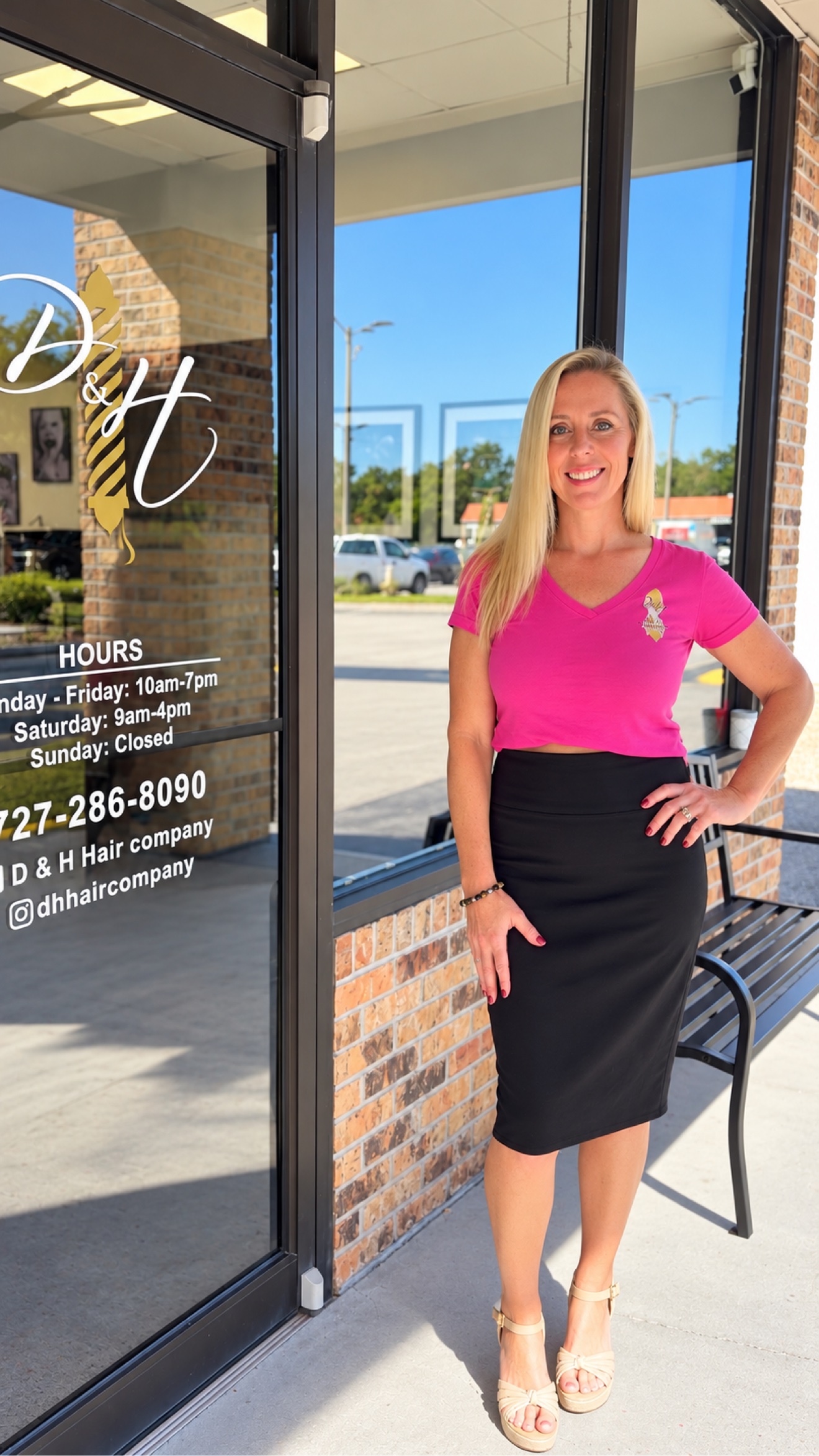 Heather, owner of D&H Hair Company, standing in front of the shop