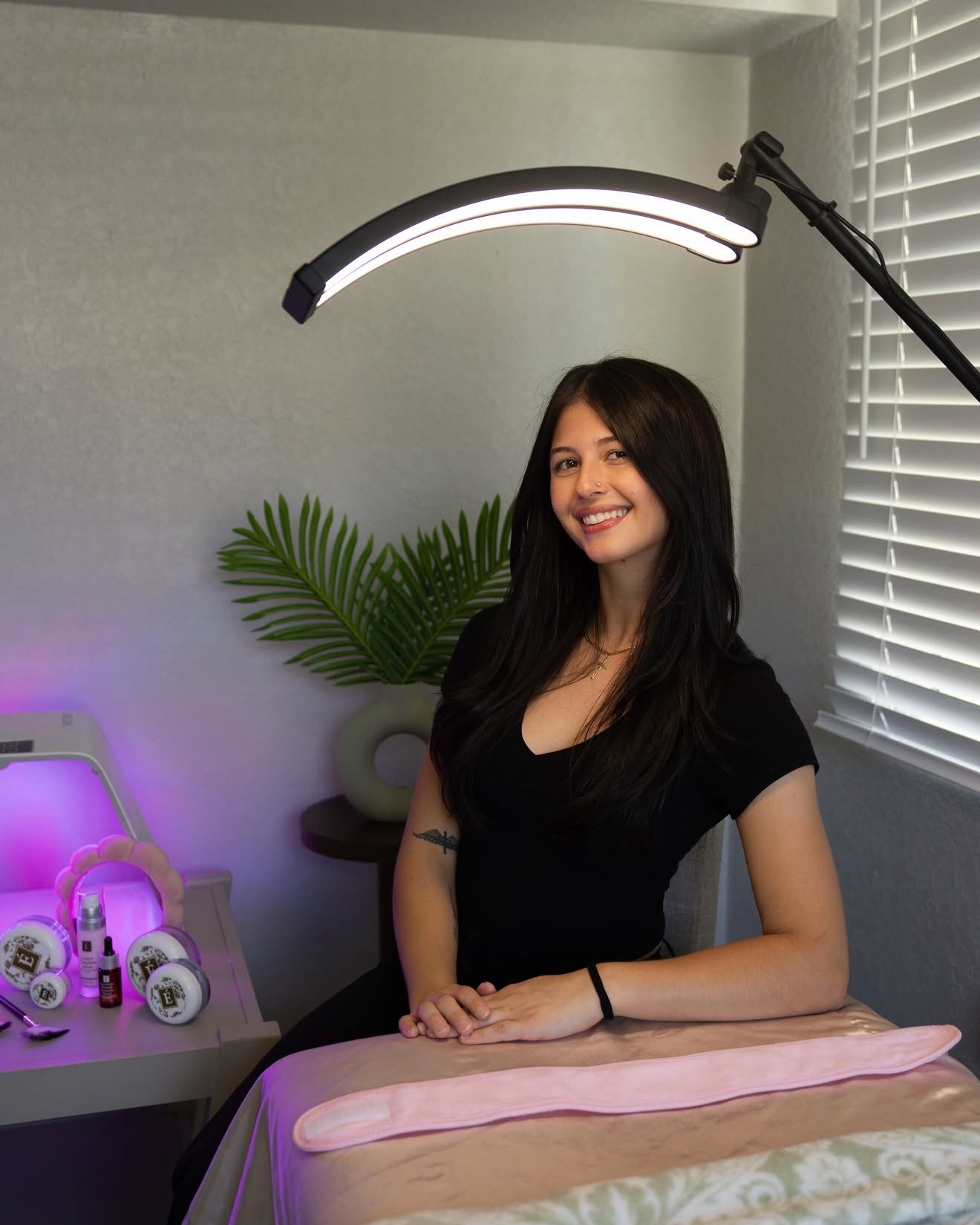 Deborah, esthetician at D&H Hair Company, smiling in her treatment room