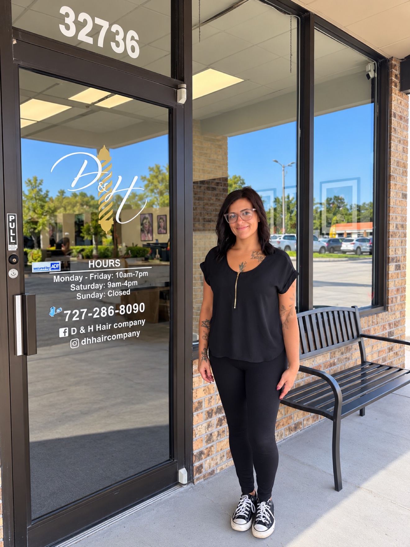 Lauren, of the D&H Hair Company team, standing in front of the shop