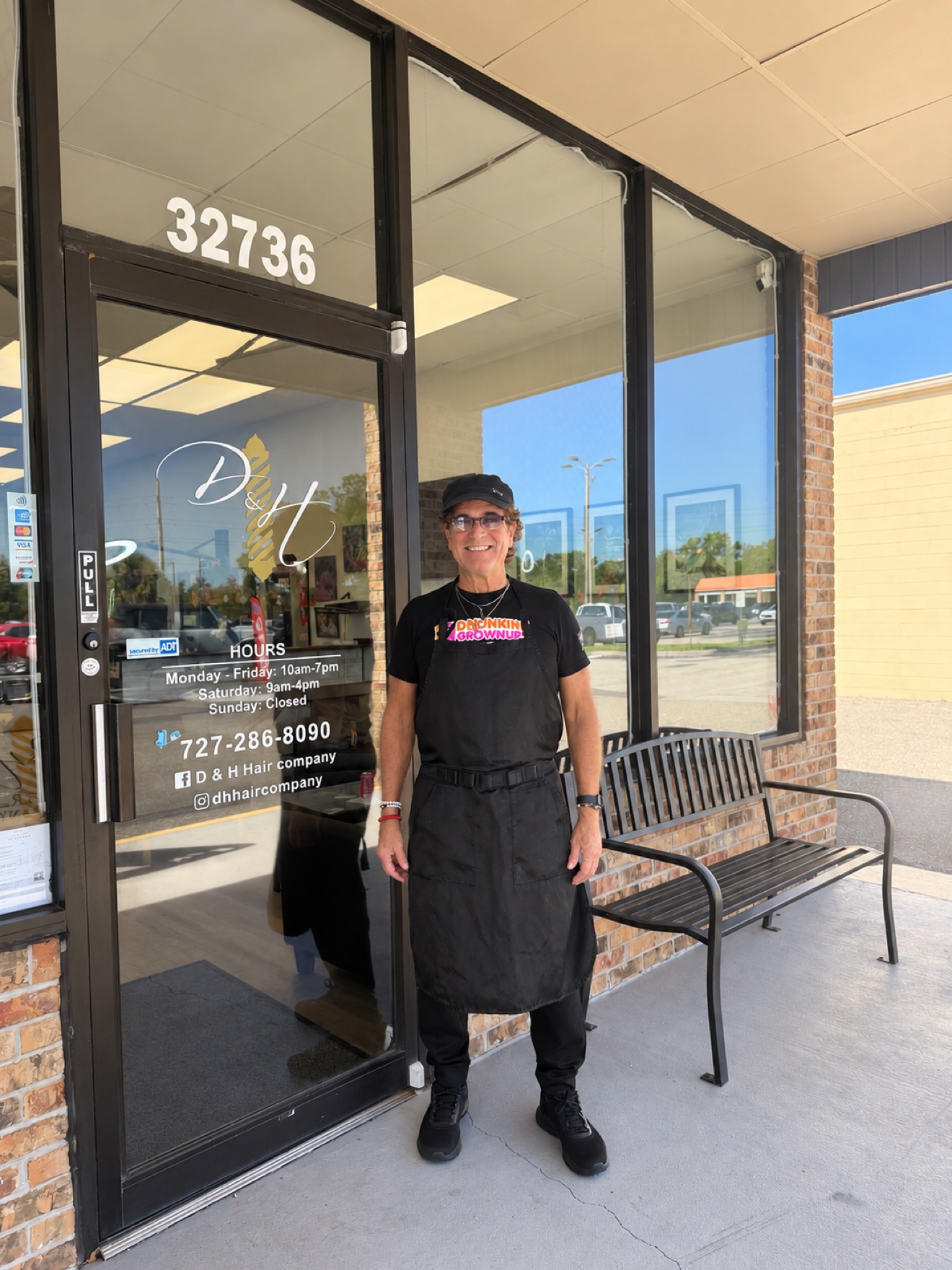 Marcus, of the D&H Hair Company team, standing in front of the shop