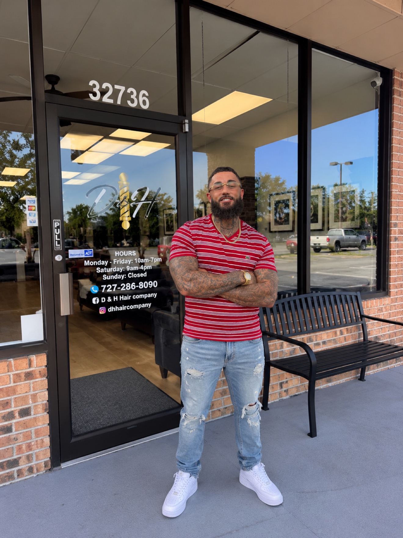Shawn, of the D&H Hair Company team, standing in front of the shop