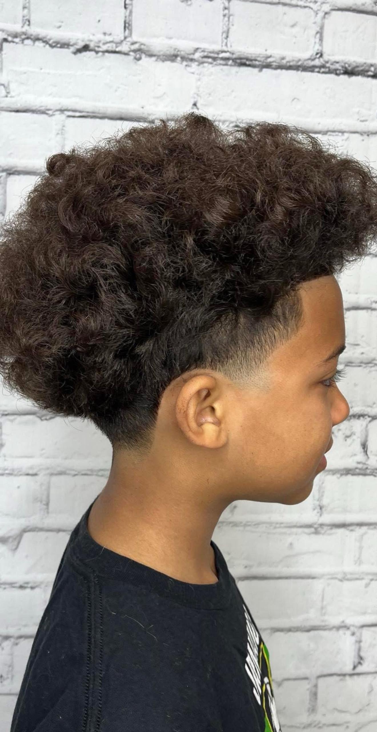 Curly high-top with a taper fade, side view, by Danny at D&H Hair Company