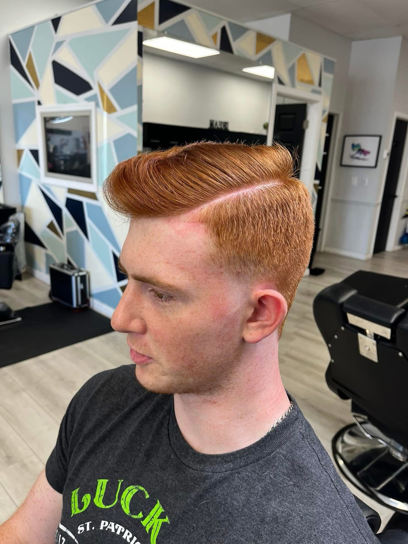 Red pompadour with a hard part, side view, by Danny at D&H Hair Company