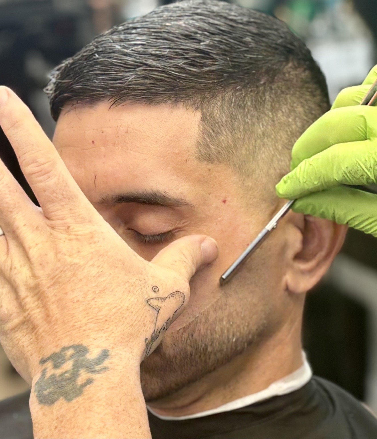 Close-up of a straight-razor lineup along the cheek during a beard trim, by Danny at D&H Hair Company