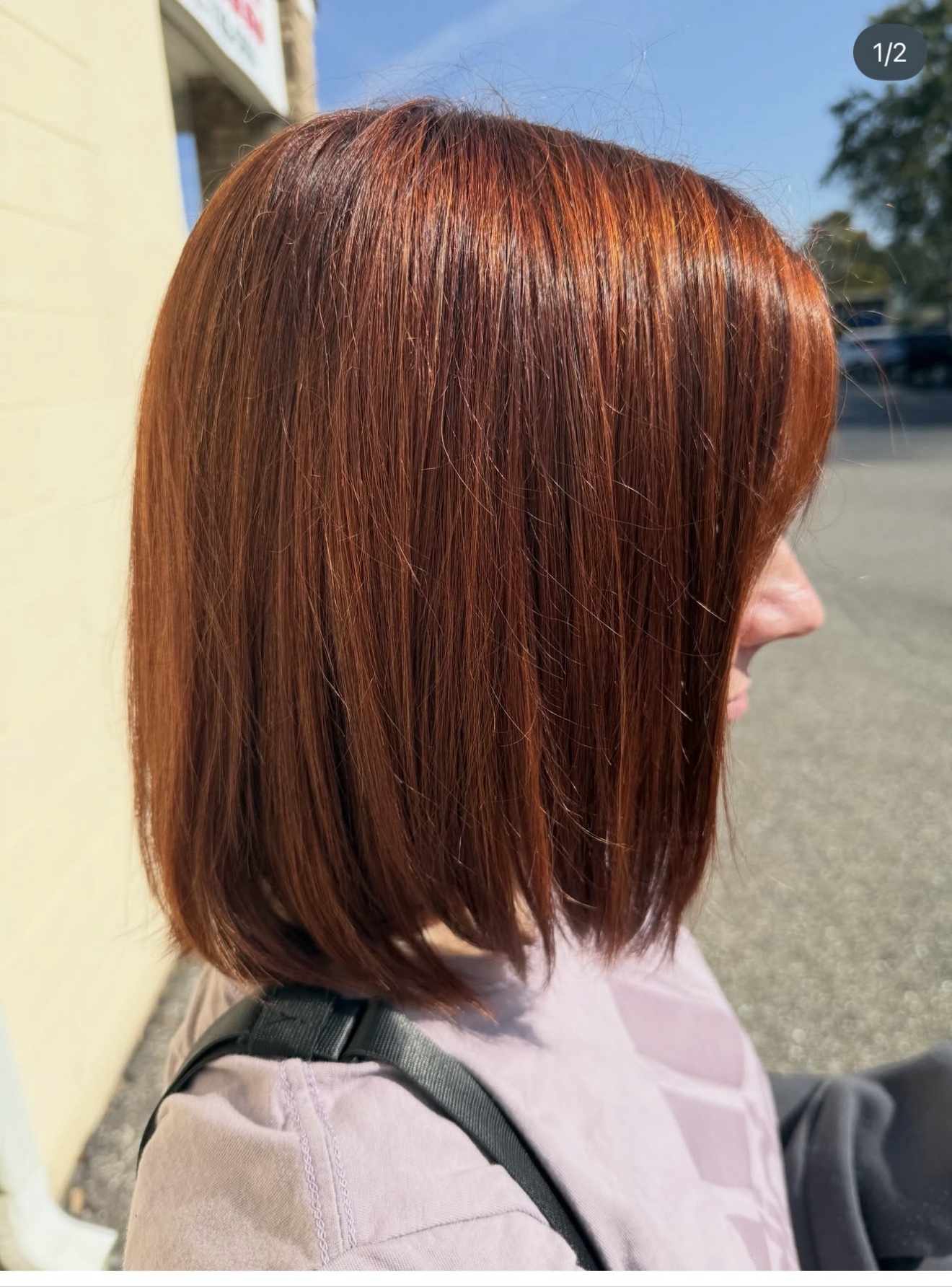 Sleek copper red bob haircut in the sunlight, side view, by Heather at D&H Hair Company