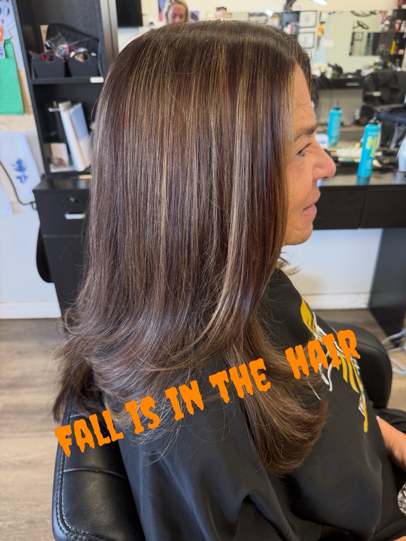 Long brunette hair with warm fall highlights, side view, by Heather at D&H Hair Company