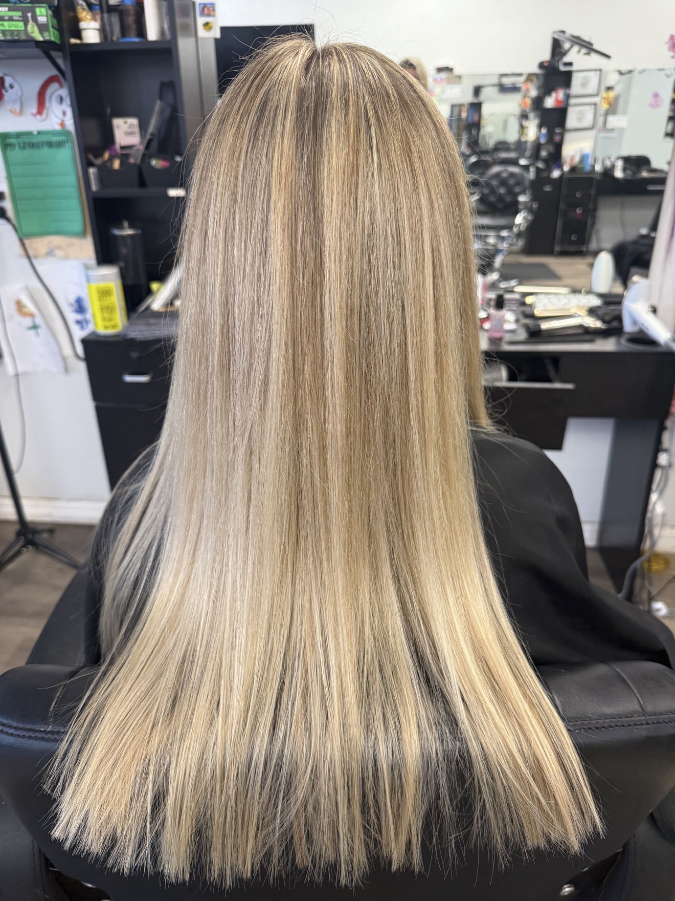 Long straight blonde hair with a smooth finish, back view, by Heather at D&H Hair Company