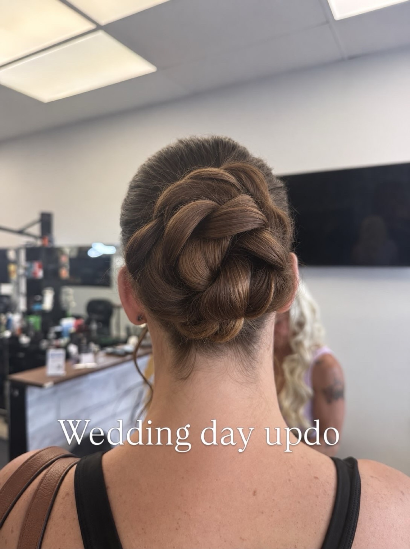 Wedding day updo with a braided bun, back view, by Heather at D&H Hair Company