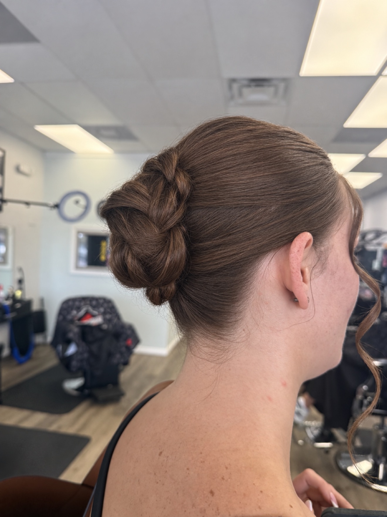 Wedding day updo with a braided bun, side view, by Heather at D&H Hair Company