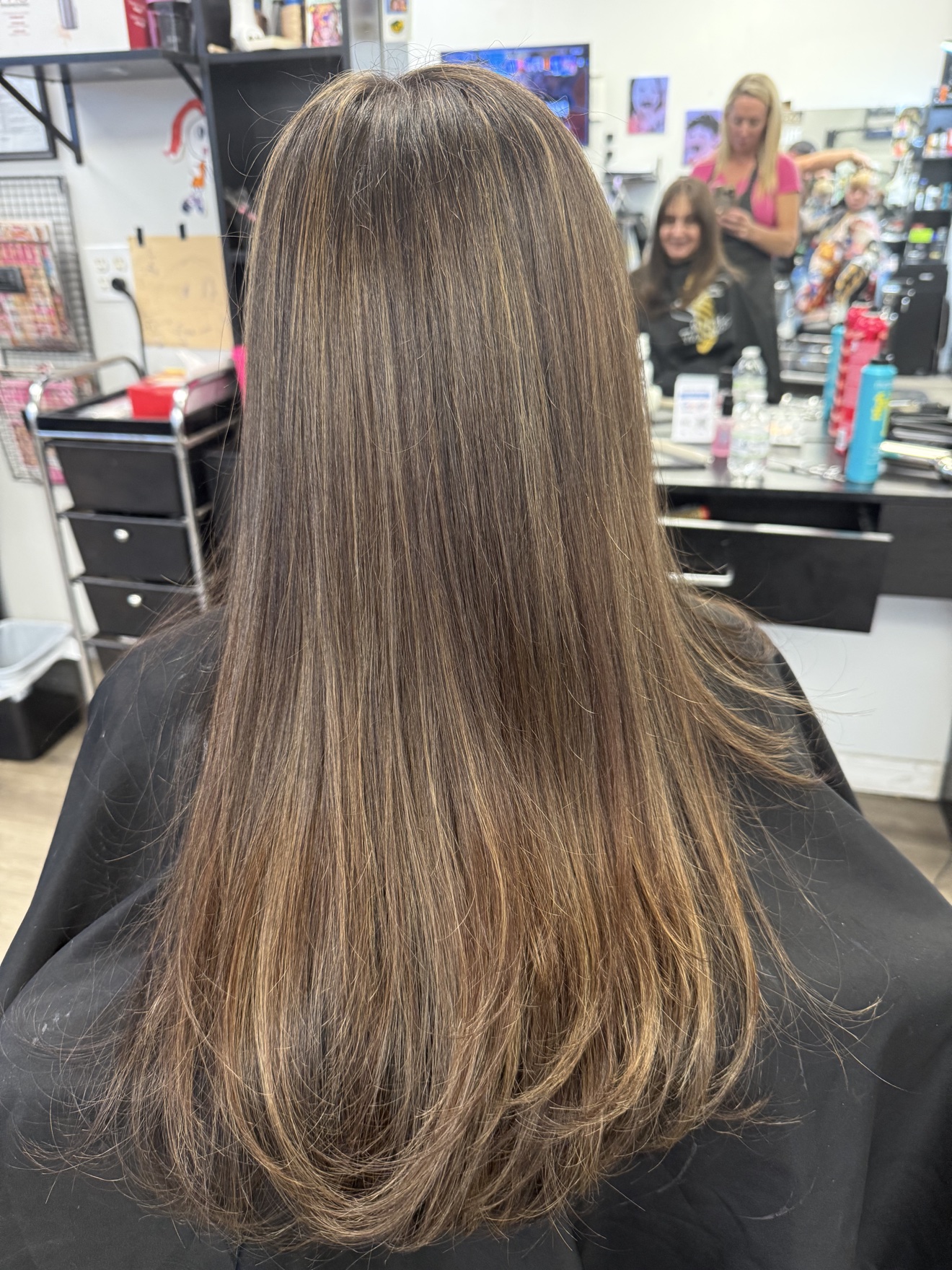 Long brunette hair with dimensional highlights, back view, by Heather at D&H Hair Company