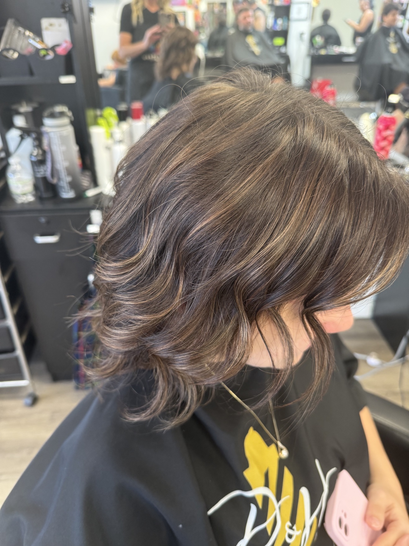 Short wavy brunette cut, side view, by Heather at D&H Hair Company