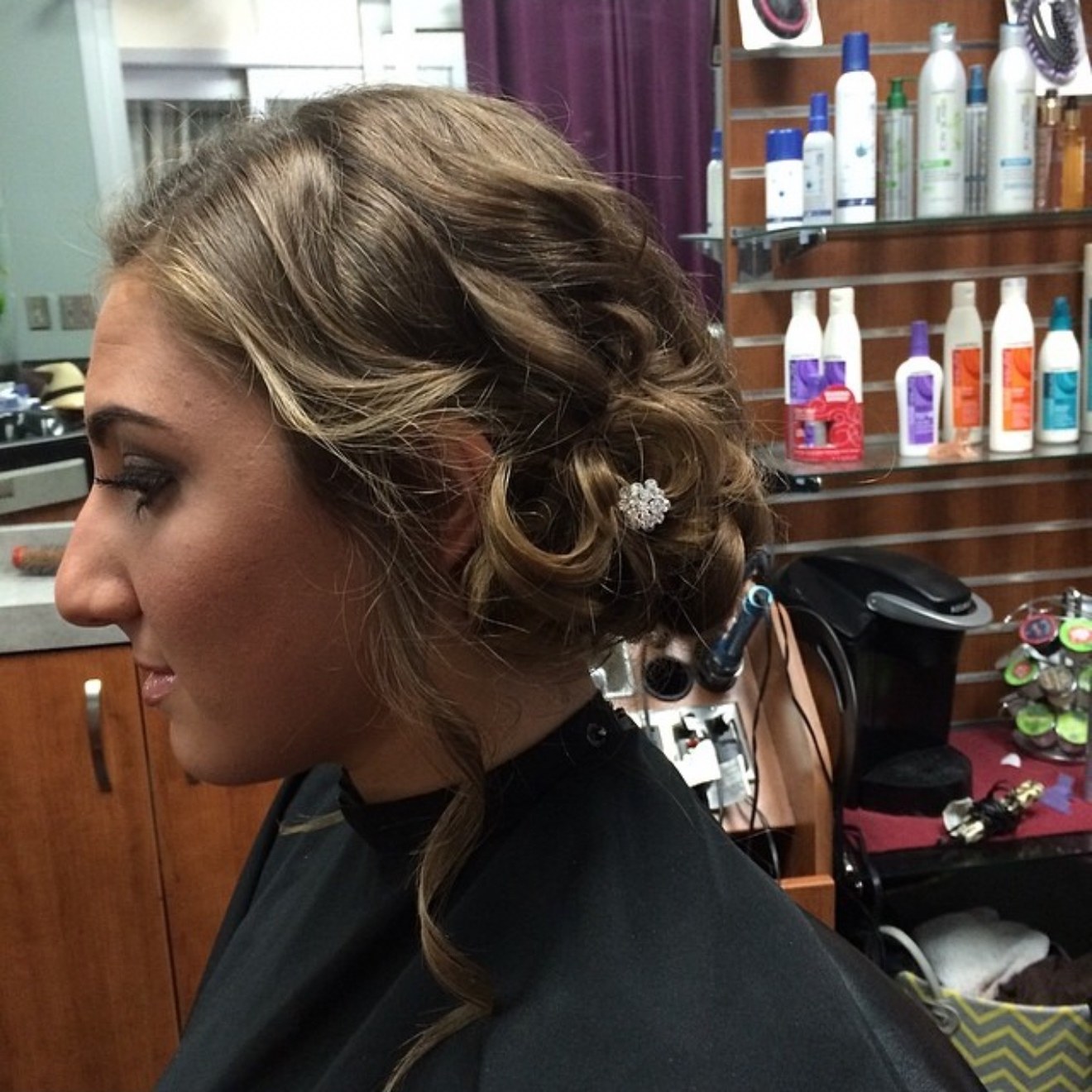 Prom updo with a jeweled hair pin, side view, by Heather at D&H Hair Company