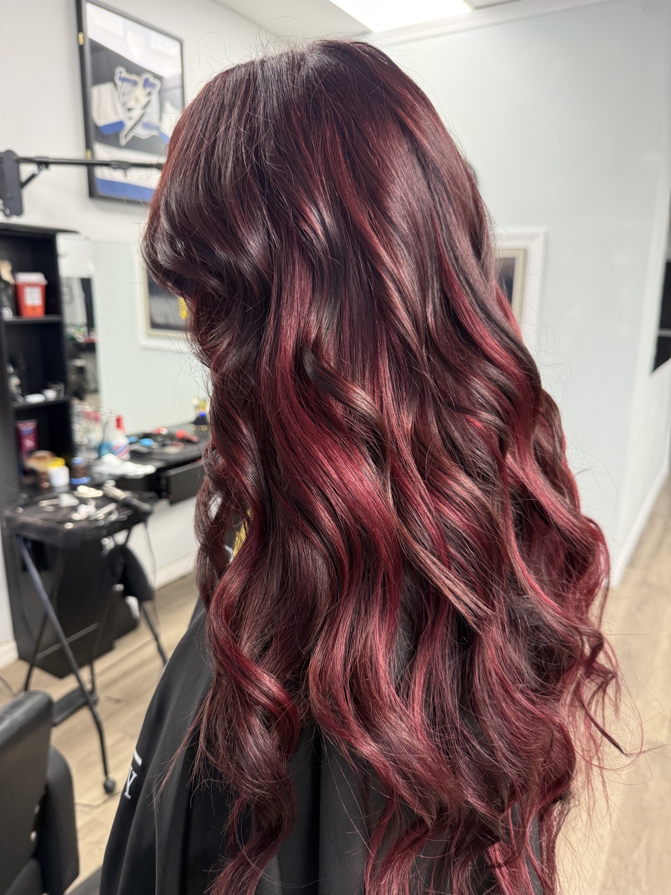 Long burgundy red wavy hair extensions, side view, by Heather at D&H Hair Company