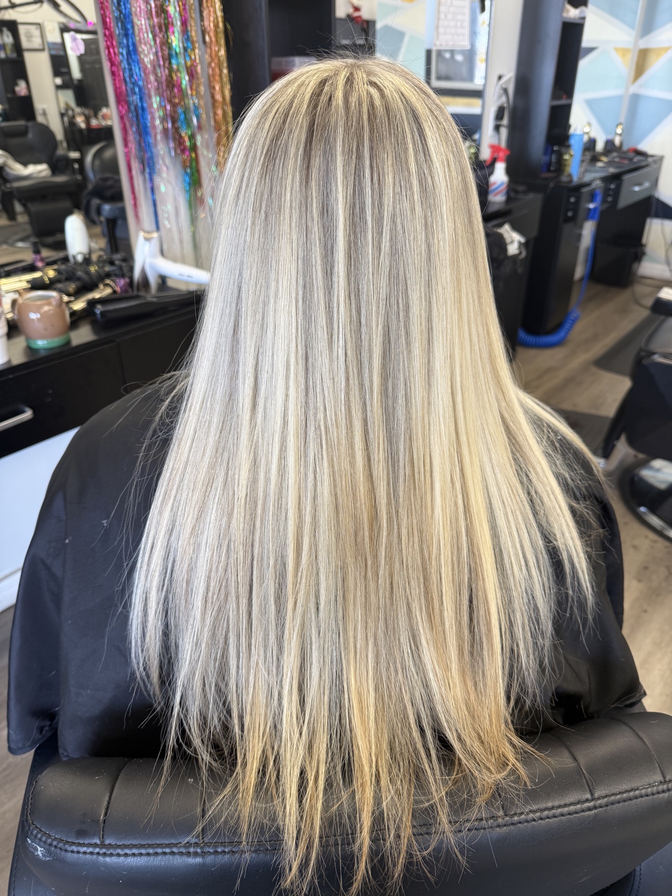Long straight platinum blonde hair with dimensional highlights, back view, by Heather at D&H Hair Company