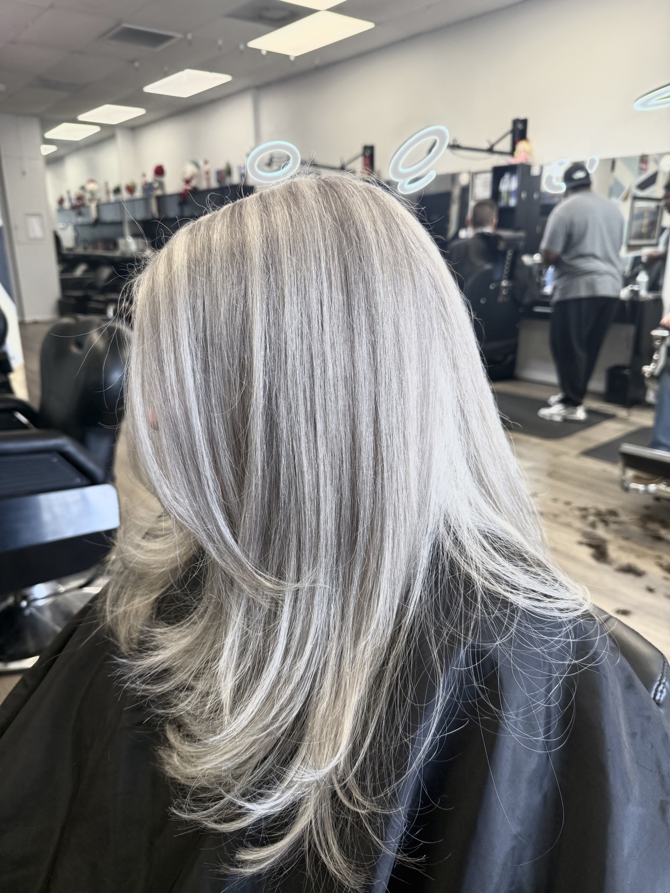 Long silver ash blonde hair with soft layers, back view, by Heather at D&H Hair Company