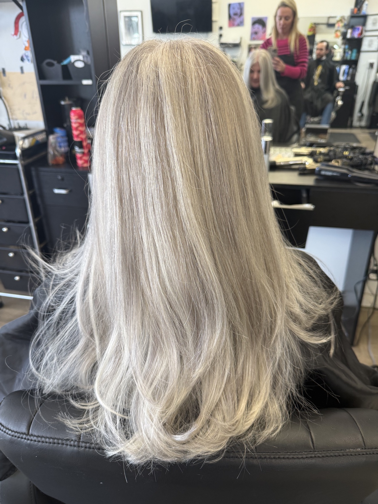 Long silver ash blonde hair with soft waves, back view, by Heather at D&H Hair Company