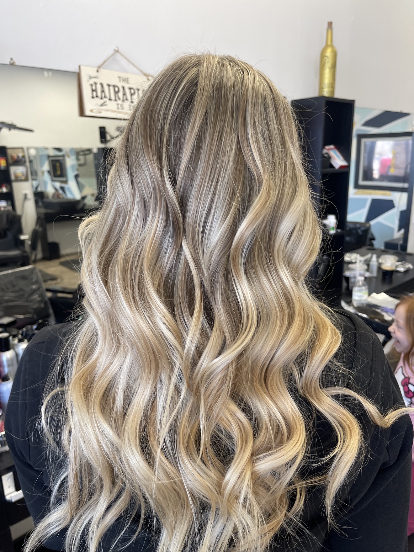 Long wavy dimensional blonde hair, back view, by Heather at D&H Hair Company