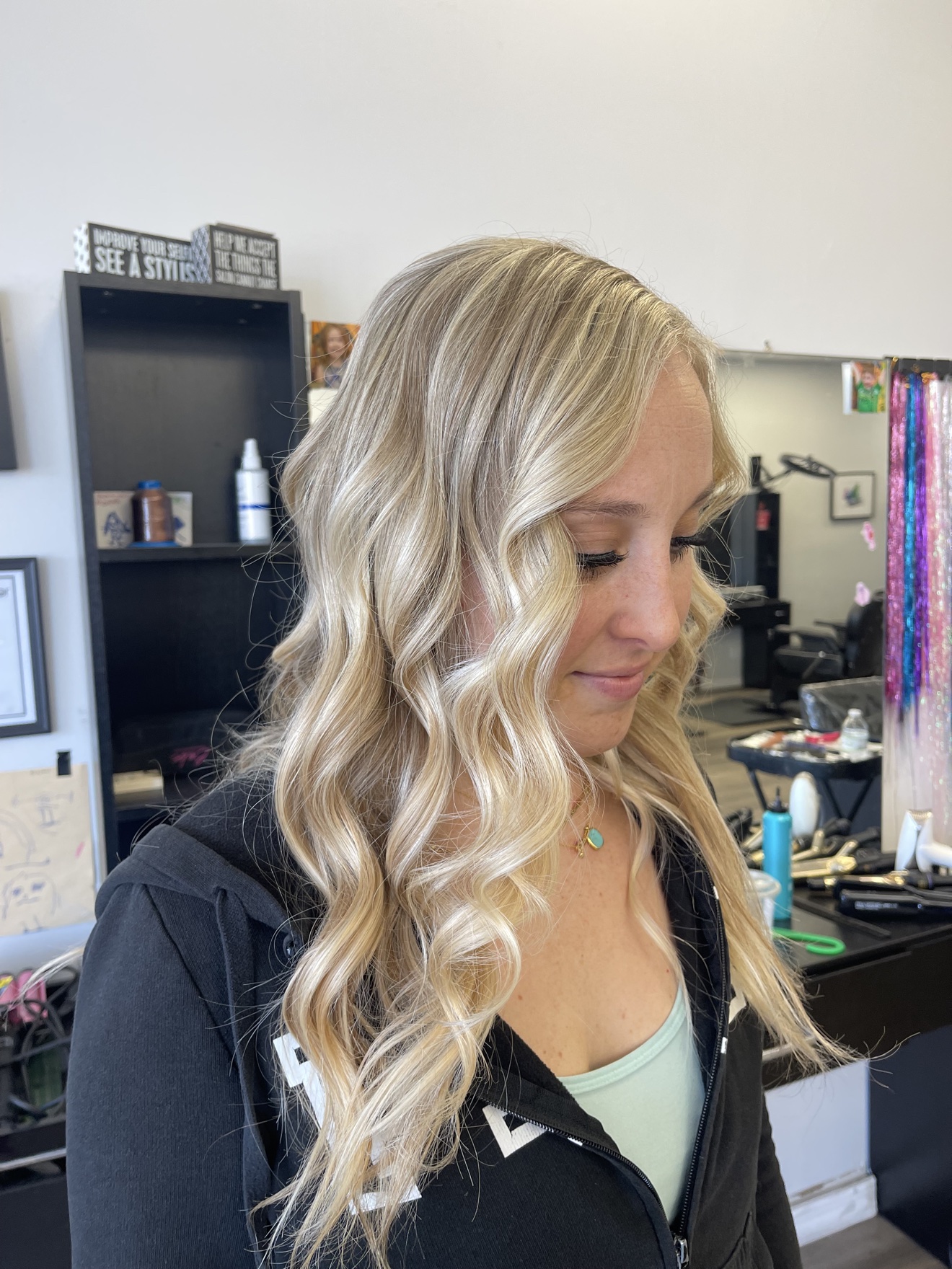 Long wavy dimensional blonde hair, side profile view, by Heather at D&H Hair Company