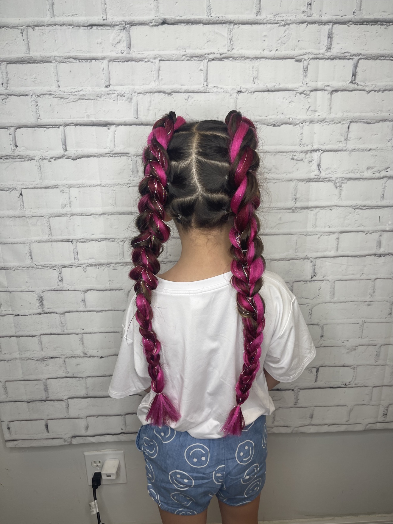 Double braids with magenta color on a young client, back view, by Heather at D&H Hair Company