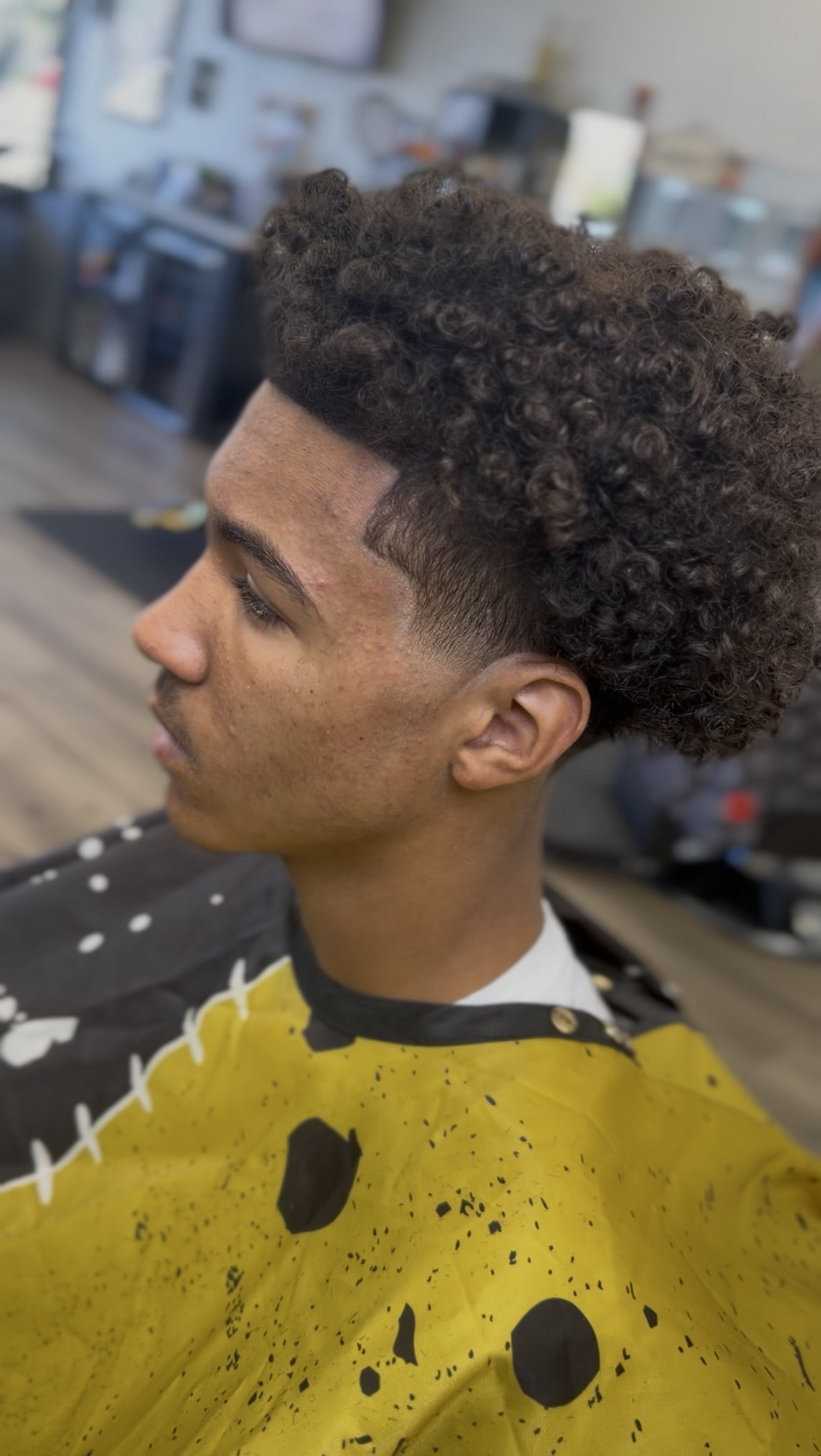Curly high-top with a lineup, side view, by Jacob at D&H Hair Company