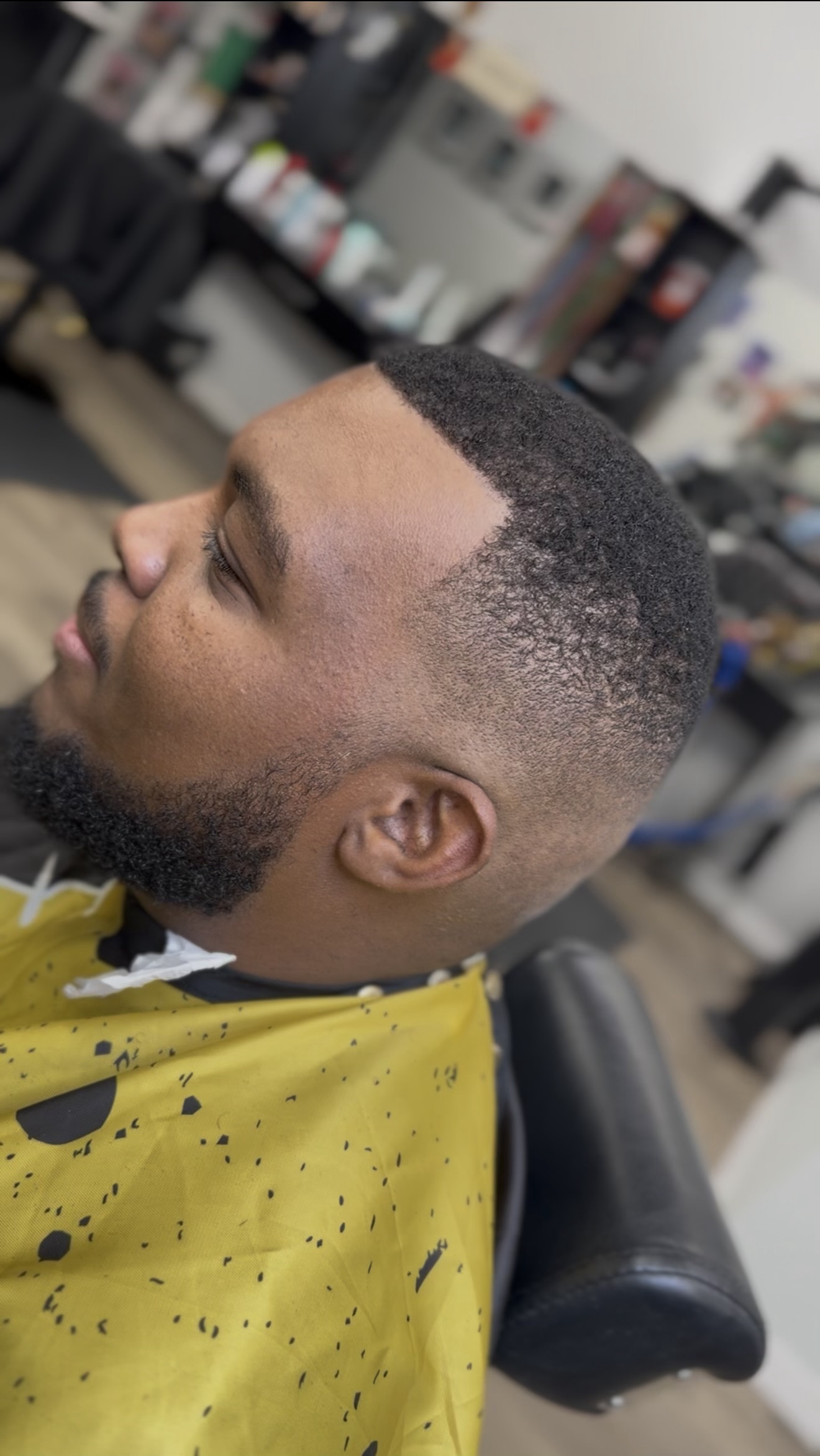 Skin fade with a shaped beard, side view, by Jacob at D&H Hair Company