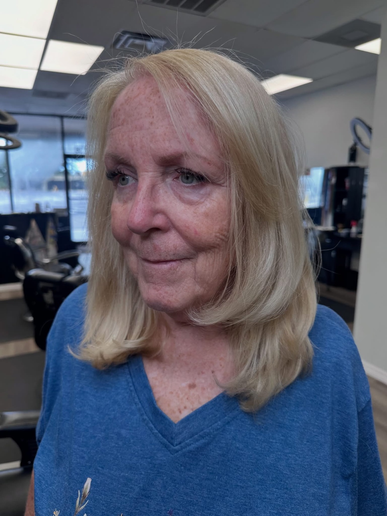 Blonde layered cut with a bouncy blowout, front view, by Lauren at D&H Hair Company