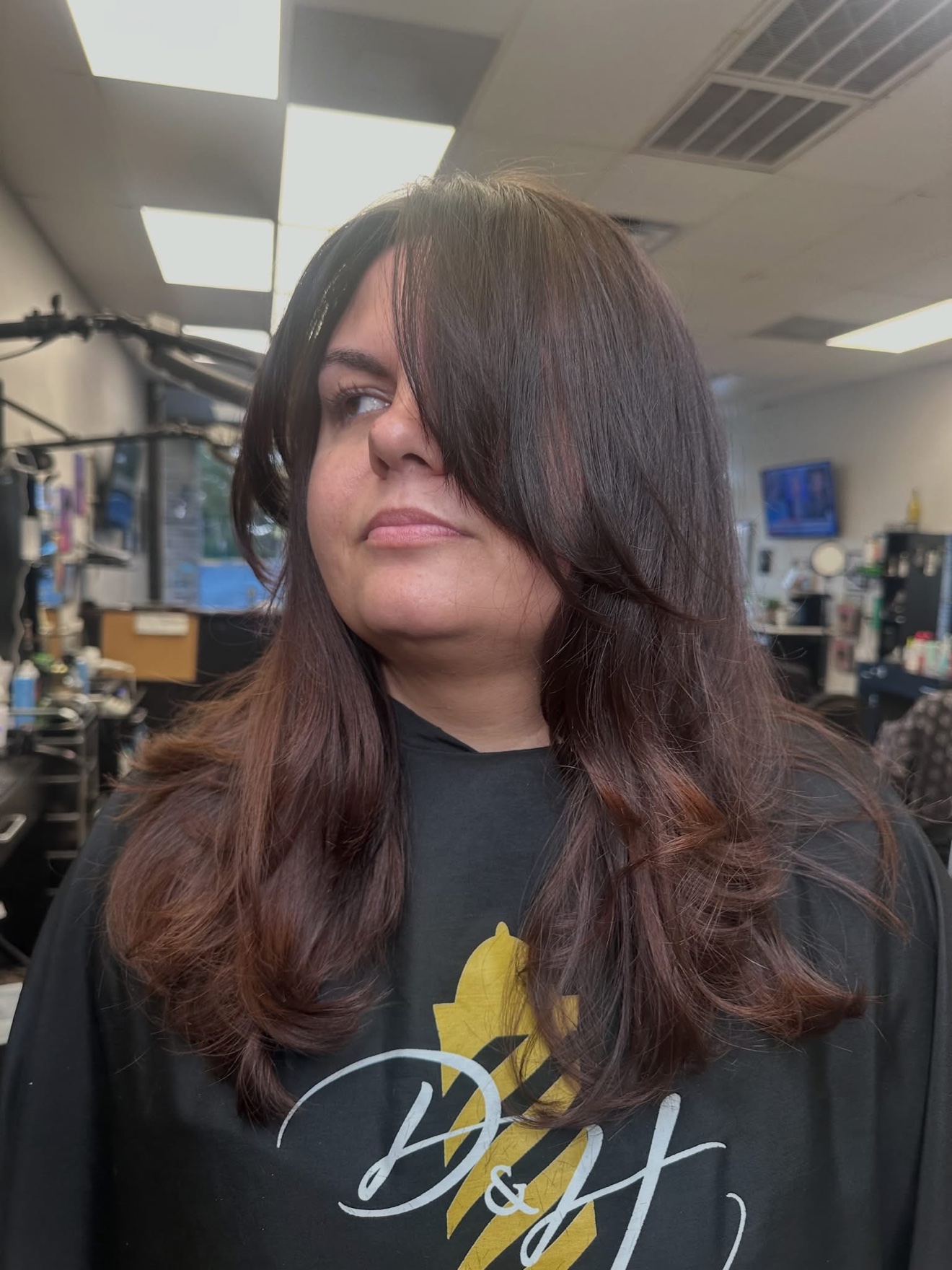 Dark brunette layered cut with face-framing layers, front view, by Lauren at D&H Hair Company