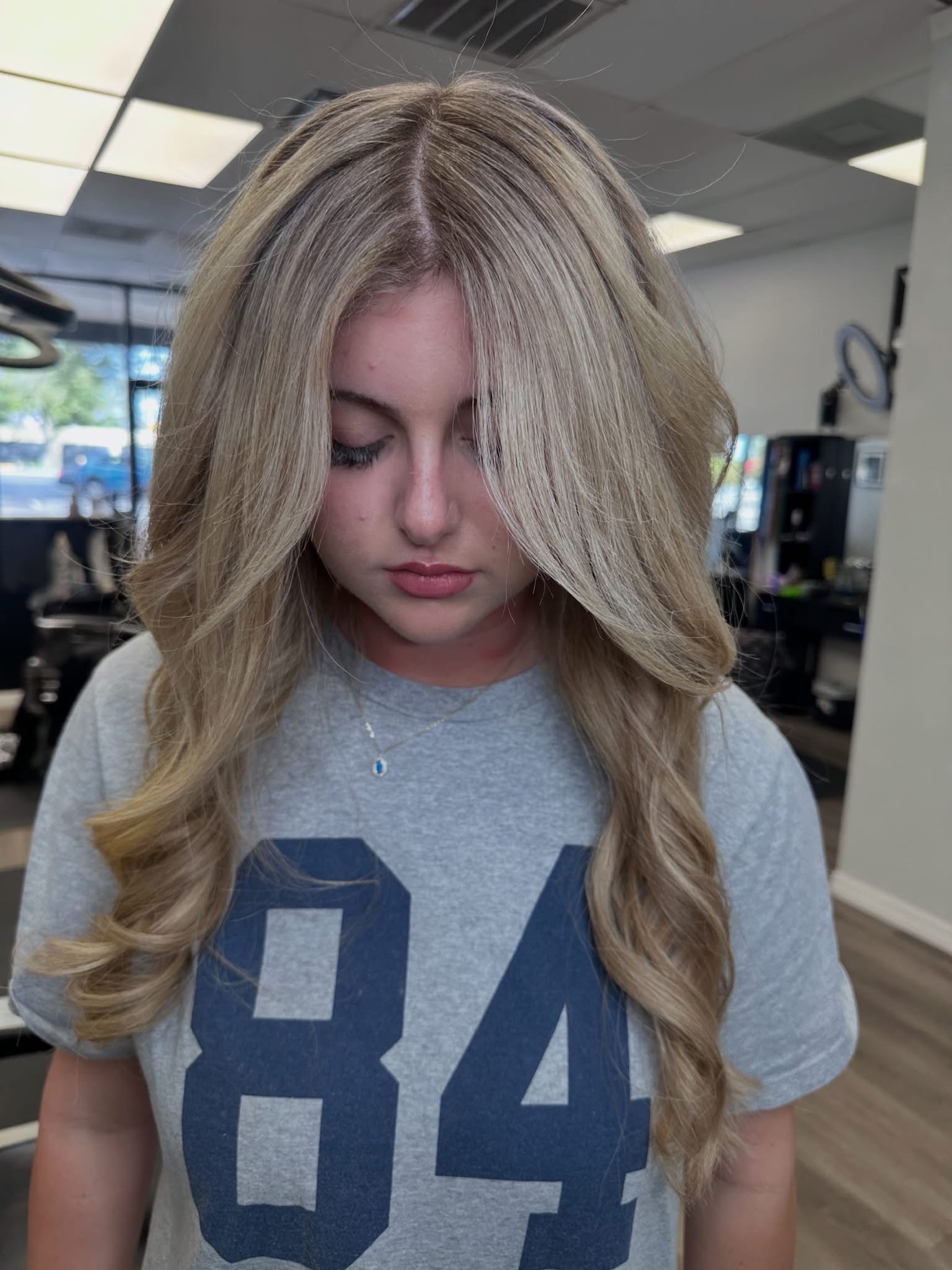 Sandy blonde wavy cut, front view, by Lauren at D&H Hair Company