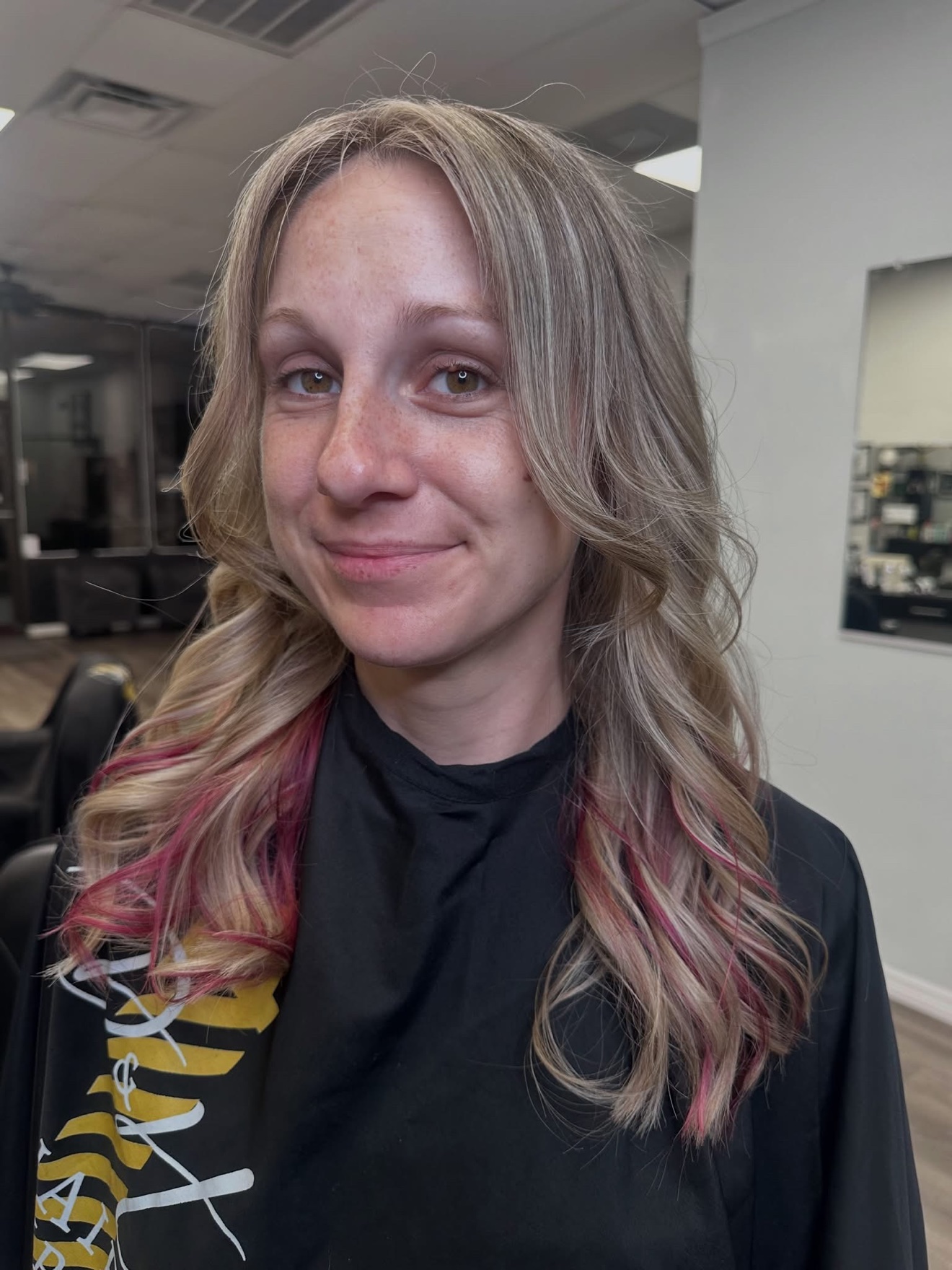 Blonde waves with pink peekaboo ends, front view, by Lauren at D&H Hair Company