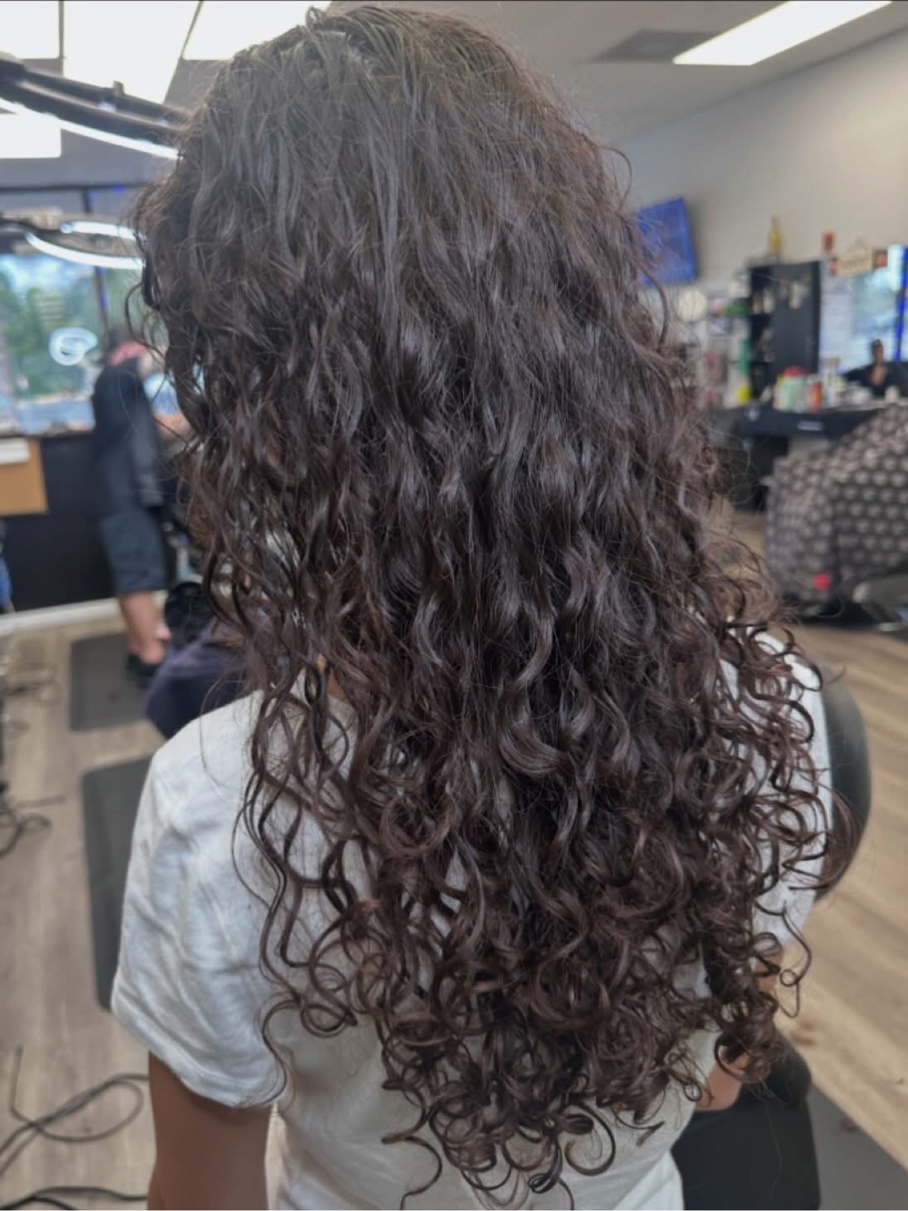 Long dark curly hair, back view, by Lauren at D&H Hair Company