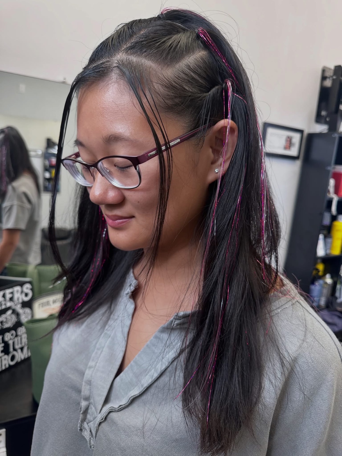 Dark hair with pink tinsel strands, side view, by Lauren at D&H Hair Company