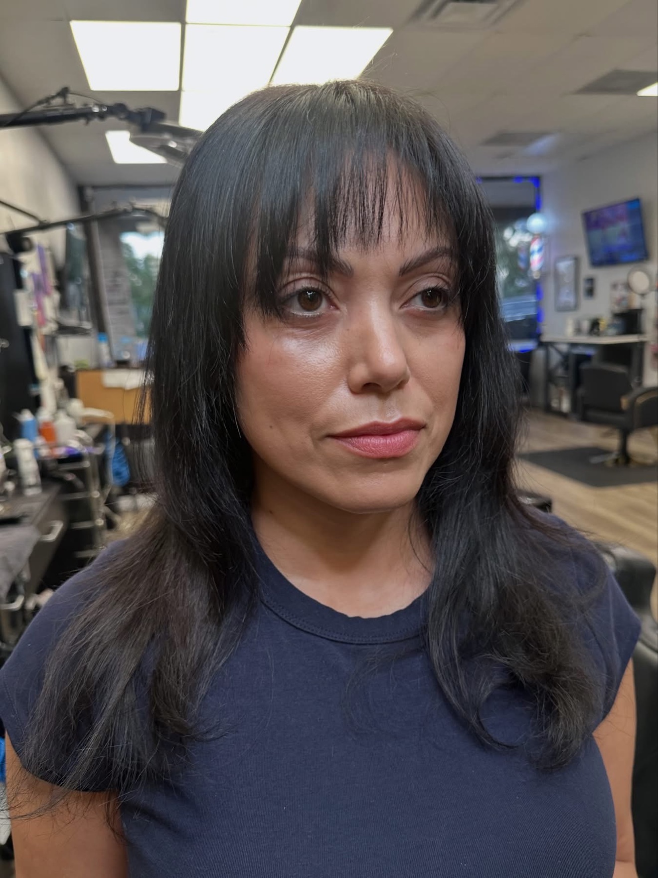 Black layered cut with bangs, front view, by Lauren at D&H Hair Company