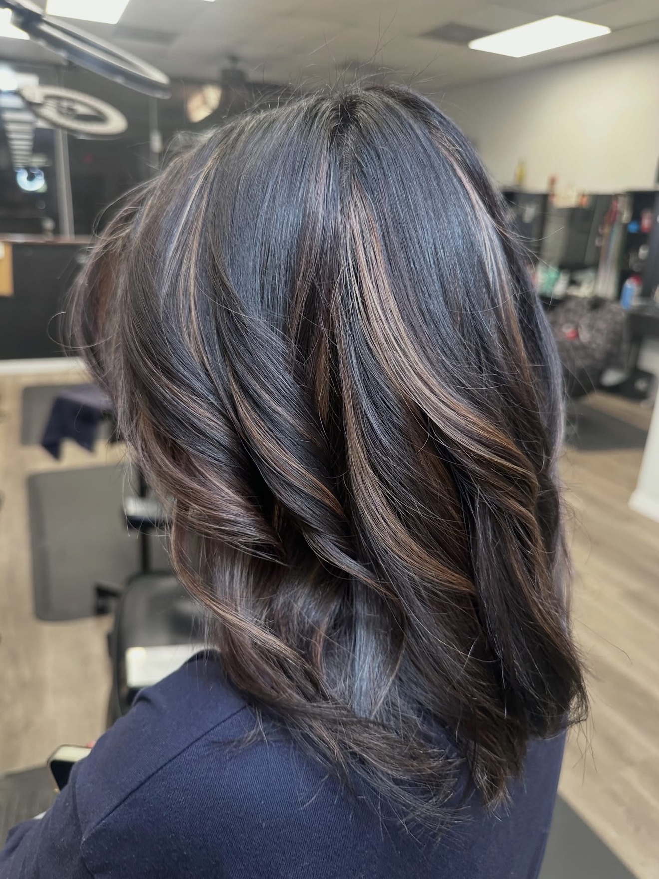 Brunette hair with warm dimensional highlights, back view, by Lauren at D&H Hair Company