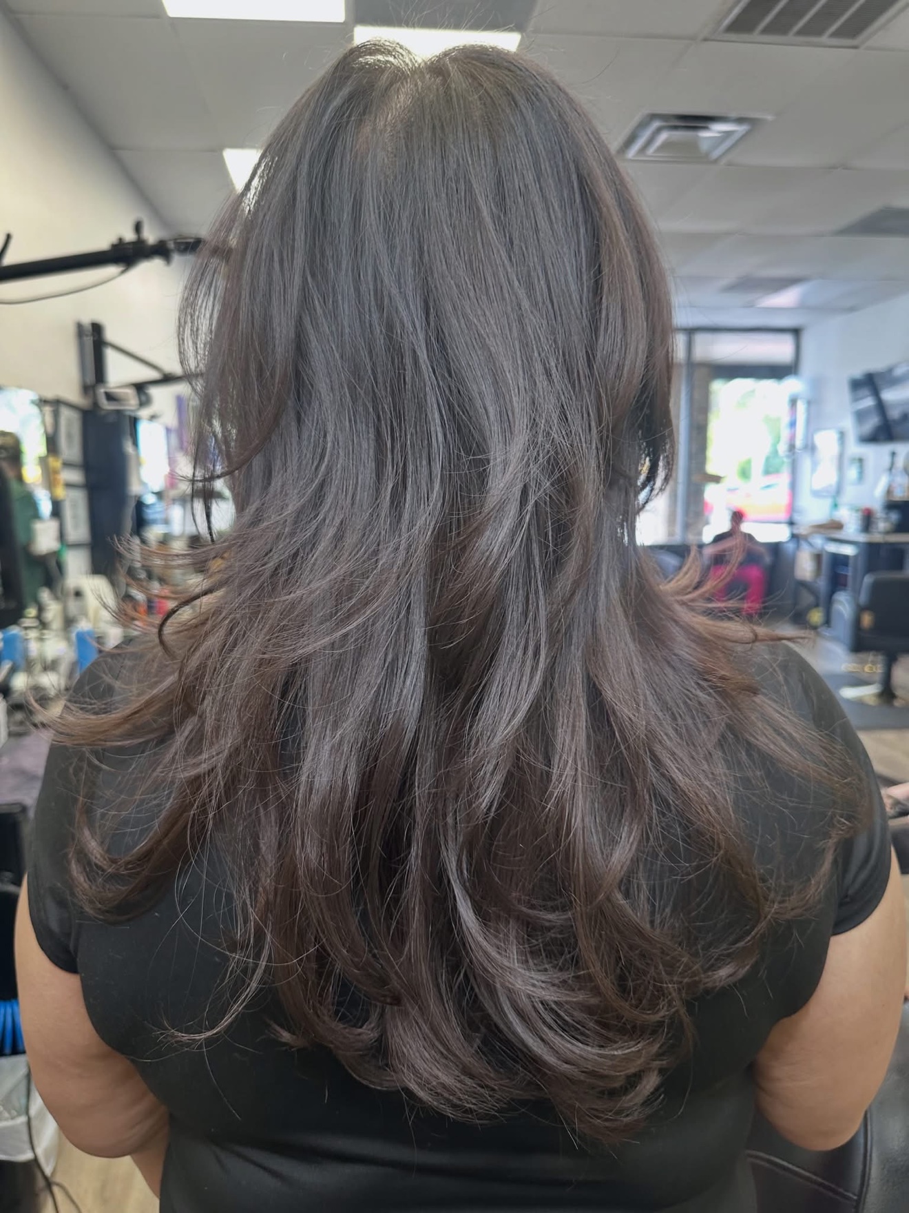 Brunette layered cut, back view, by Lauren at D&H Hair Company