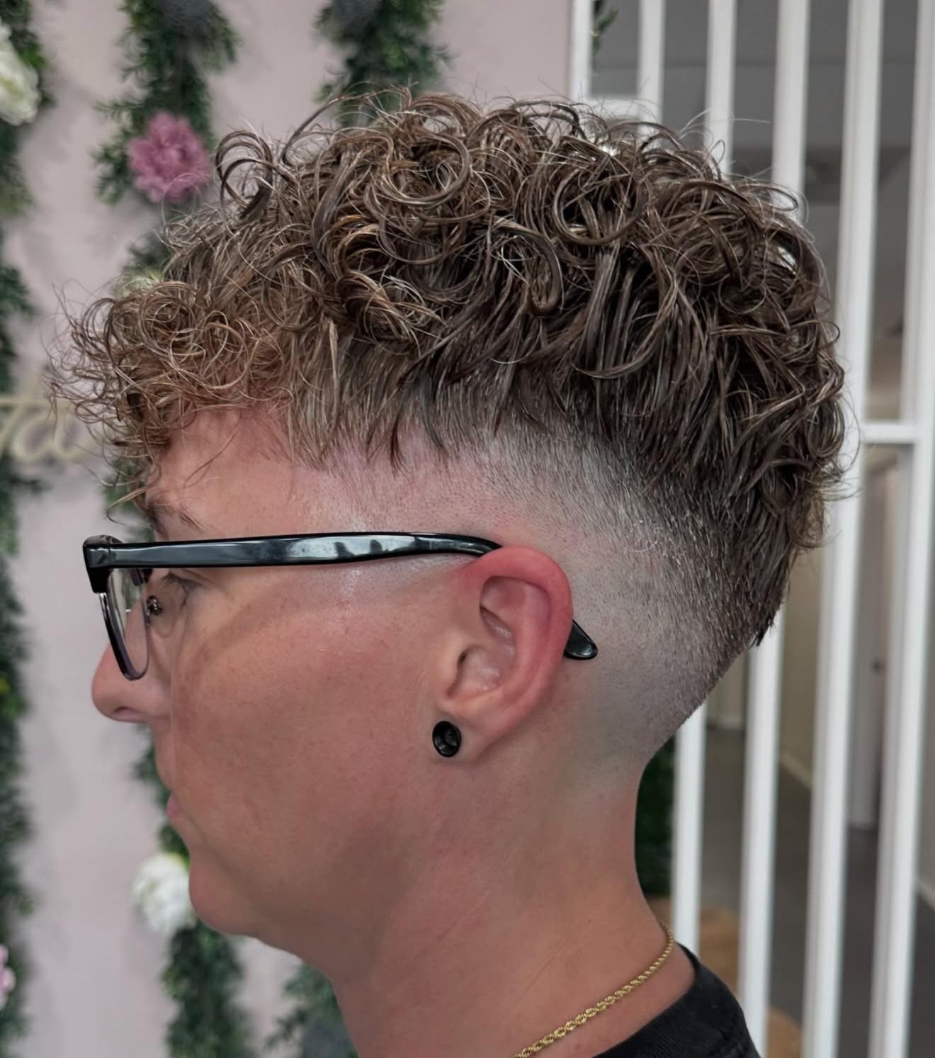 Curly perm with a fade, side view, by Lauren at D&H Hair Company
