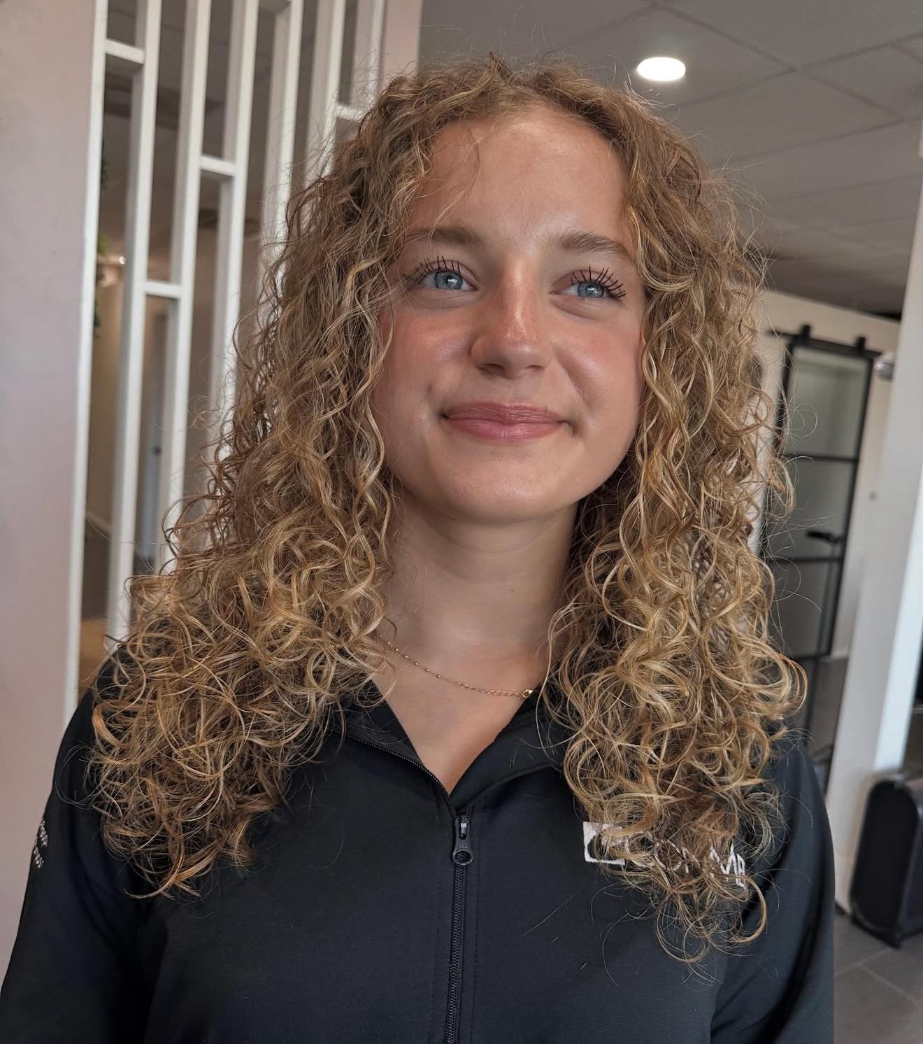 Long blonde curly hair, front view, by Lauren at D&H Hair Company