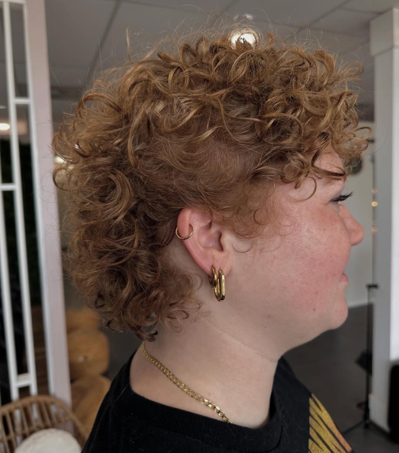 Short curly light brown cut, side view, by Lauren at D&H Hair Company