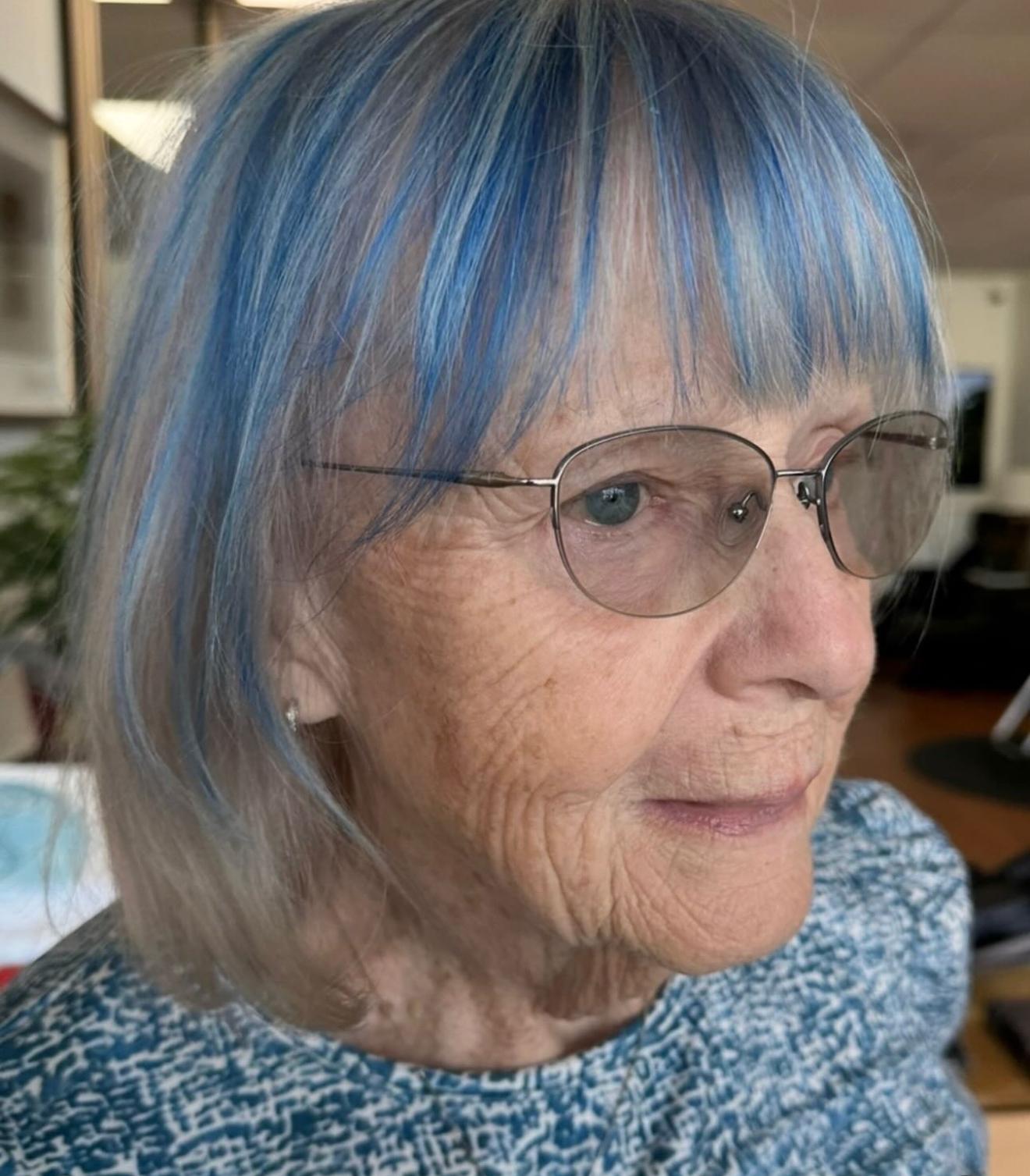 Grey bob with blue streaks, side view, by Lauren at D&H Hair Company