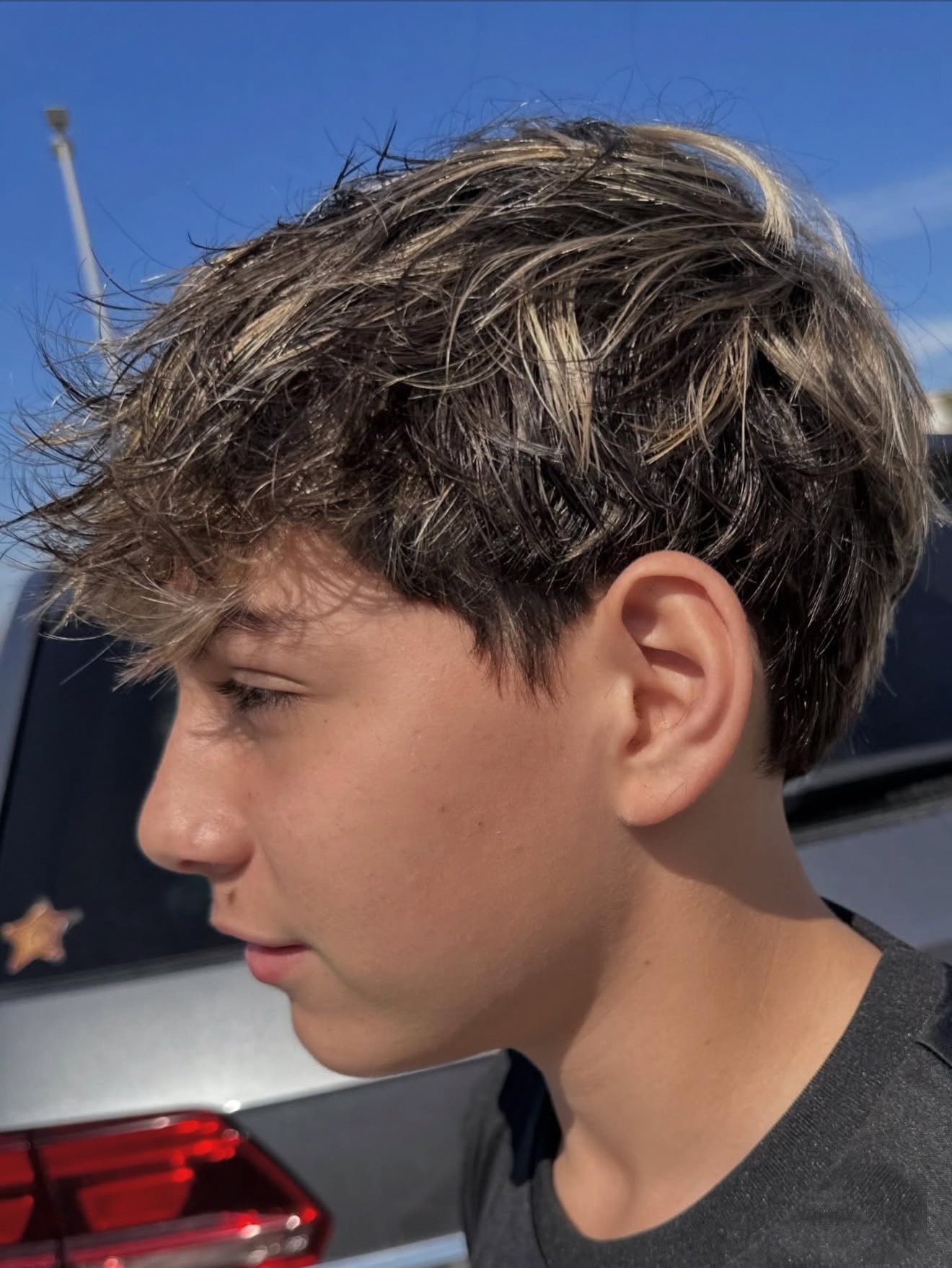 Young men&rsquo;s fluffy cut with cap highlights, side view, by Lauren at D&H Hair Company