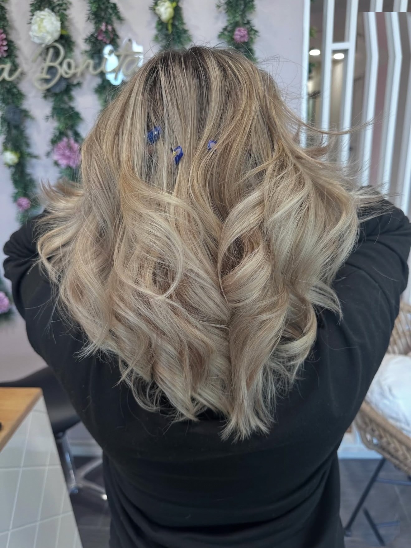 Long blonde waves with a root smudge, back view, by Lauren at D&H Hair Company
