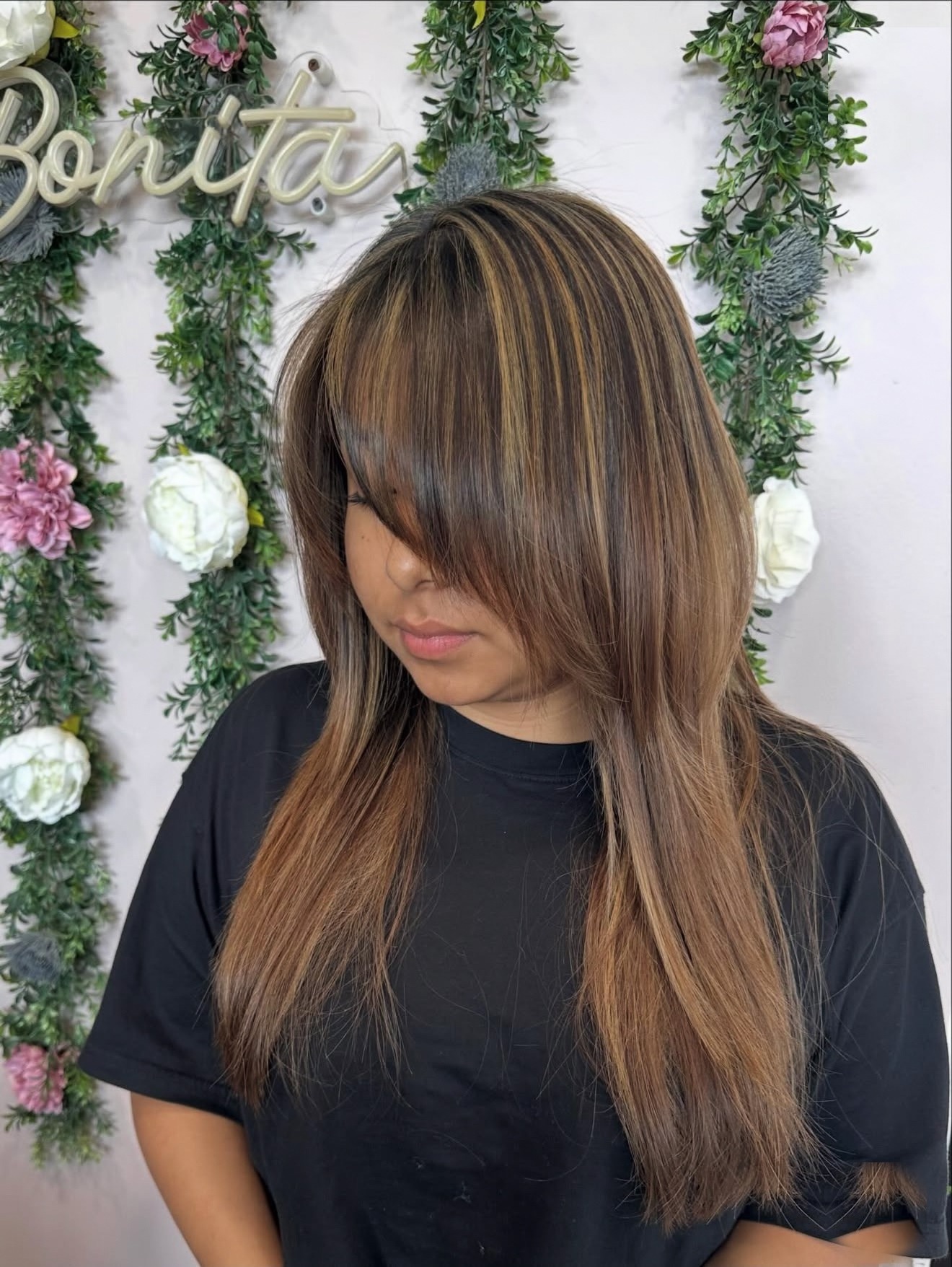 Long brunette hair with caramel highlights, front view, by Lauren at D&H Hair Company