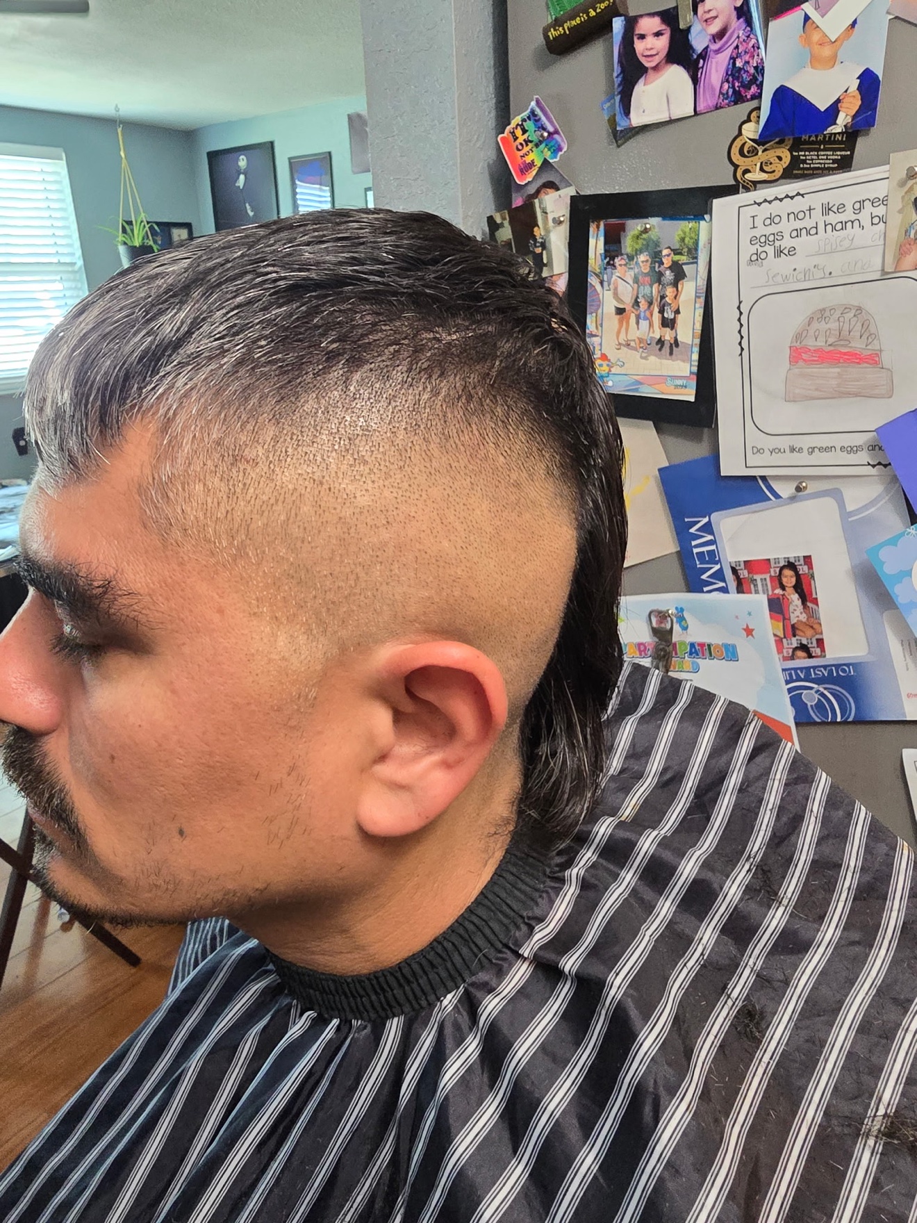 Mullet-style cut with faded sides and length in back, side view, by Rae at D&H Hair Company