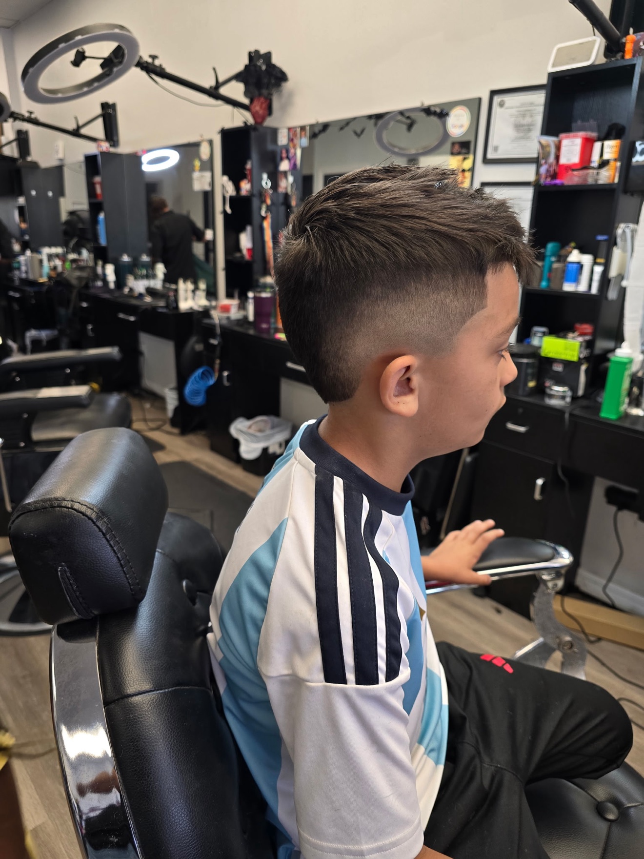 Kid&rsquo;s fade with a textured top, side view, by Rae at D&H Hair Company
