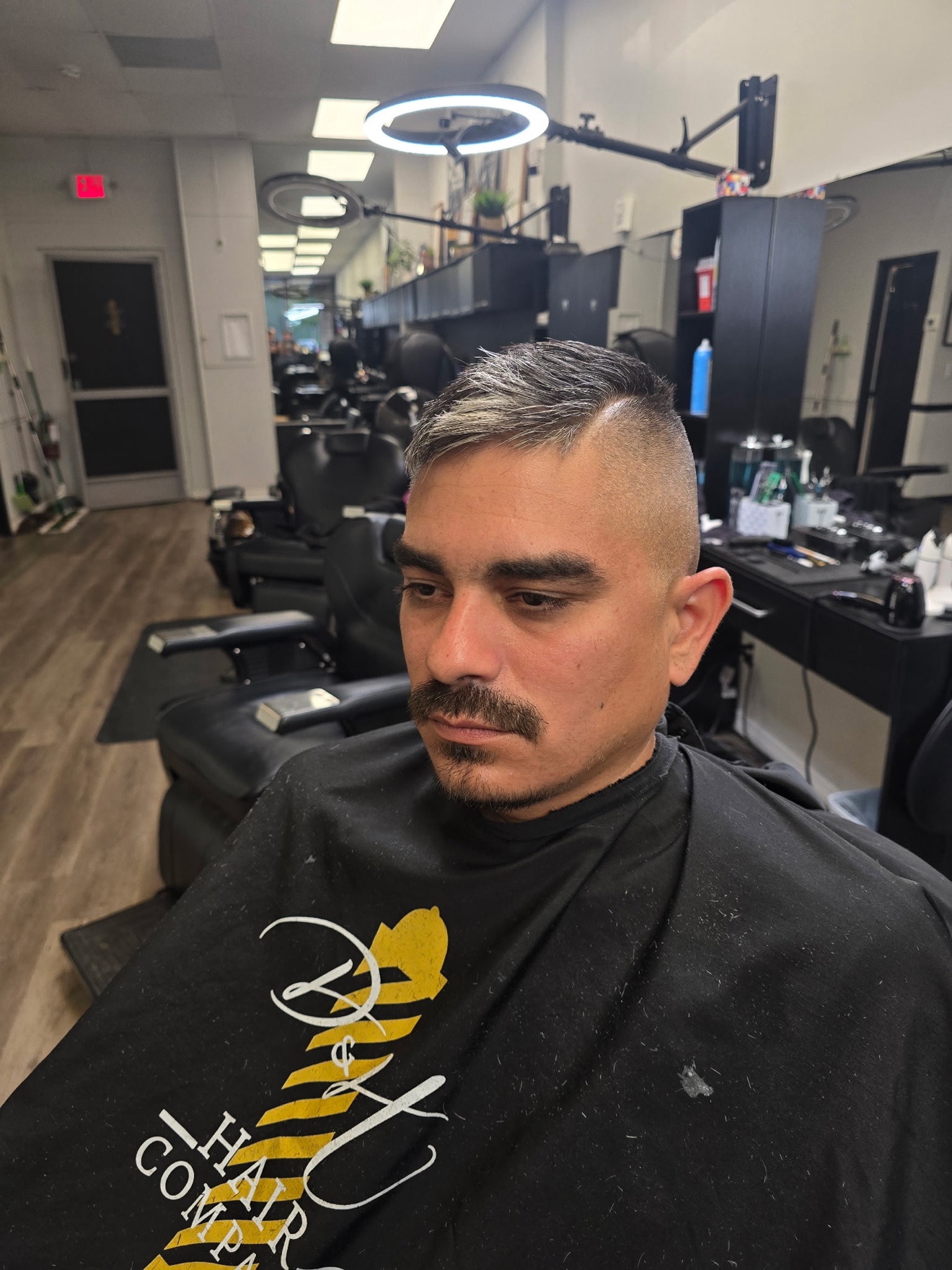 Skin fade with a side part, front view, by Rae at D&H Hair Company