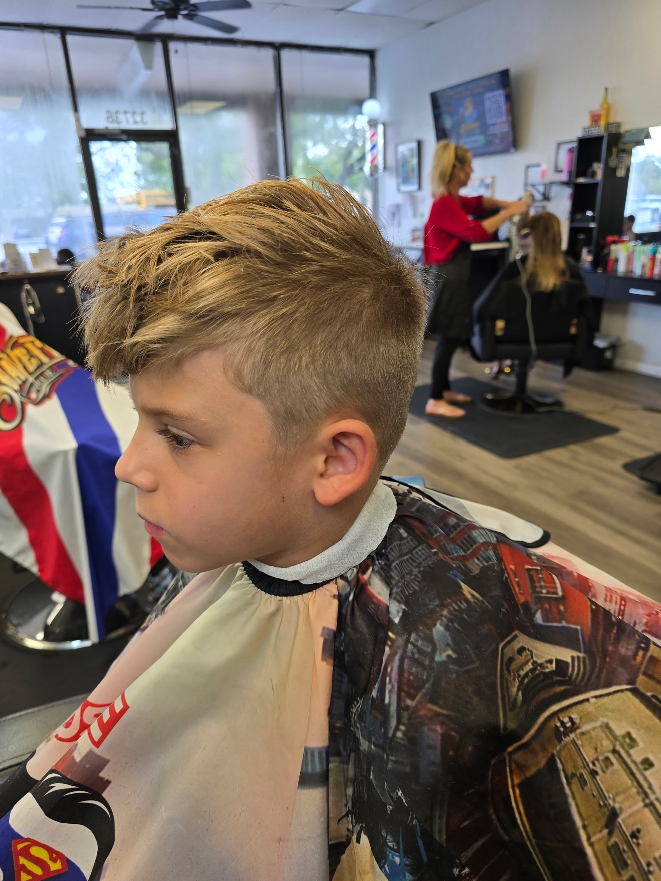 Kid&rsquo;s cut with a textured top and low taper, side view, by Rae at D&H Hair Company